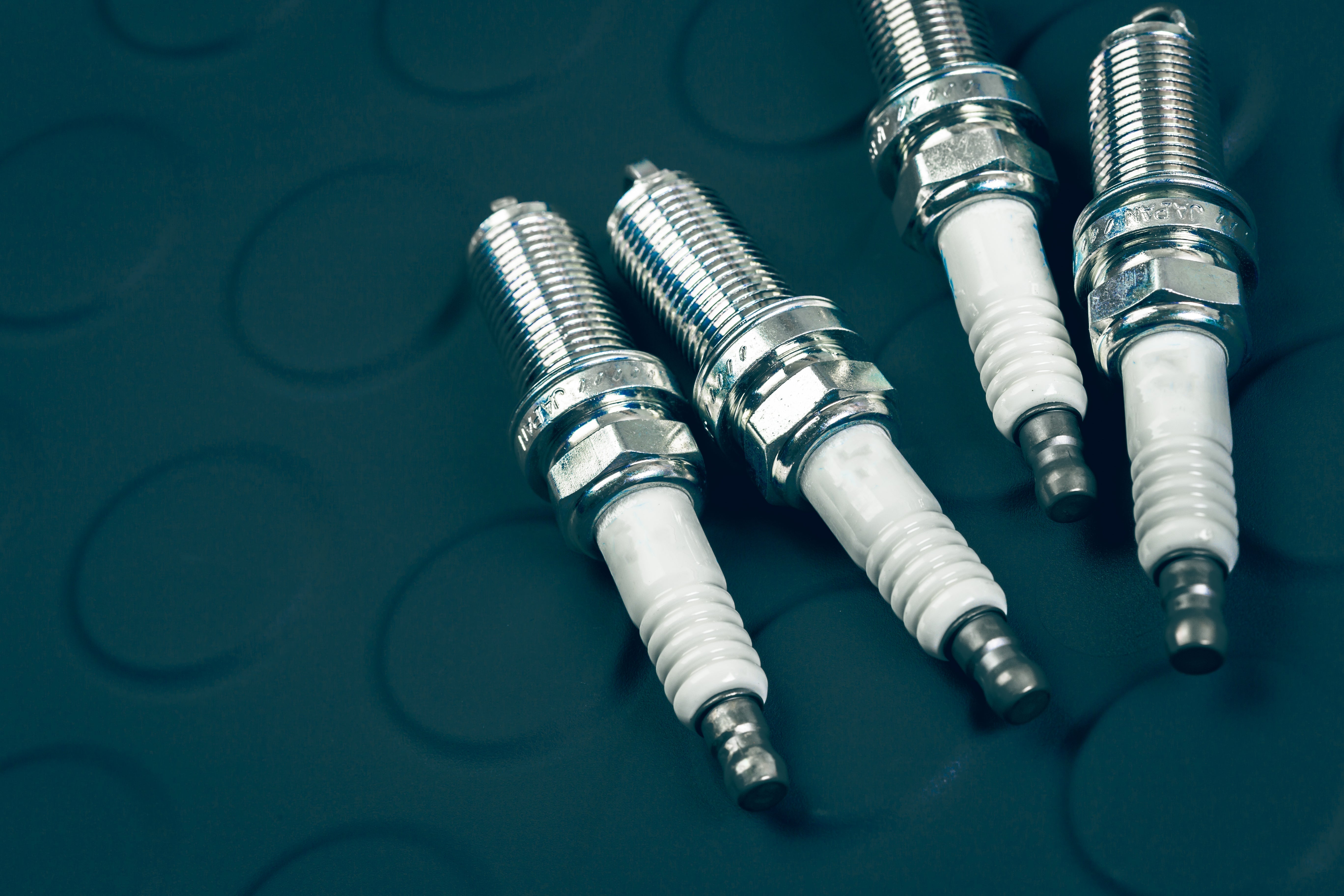Industrial Spark Plugs on a gas engine as part of ignition system maintenance to prevent performance drift.